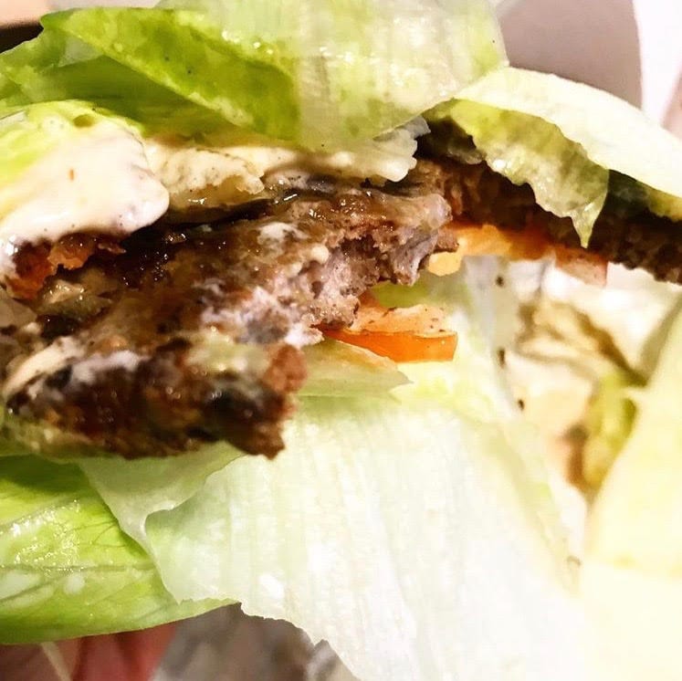 Bunless burger wrapped in lettuce.
