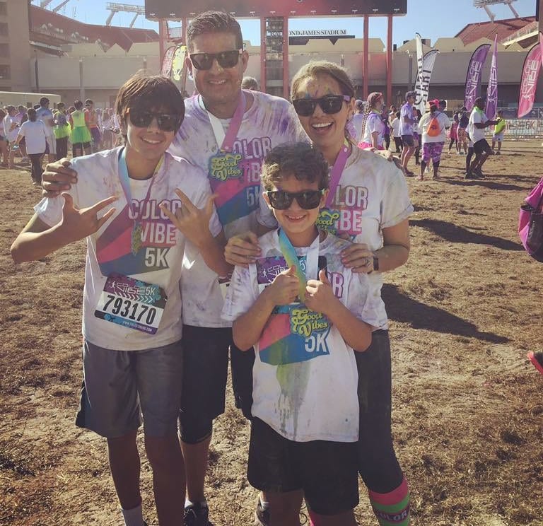 Hazely posing after a color run with her family.