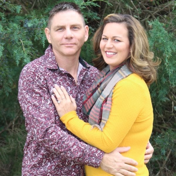 Amanda in a yellow sweatshirt and her fiance Sam in a red patterned button down.