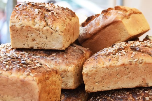 Loaves of bread topped with herbs.