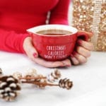 Woman holding Keto Peppermint Hot Cocoa in a red mug.