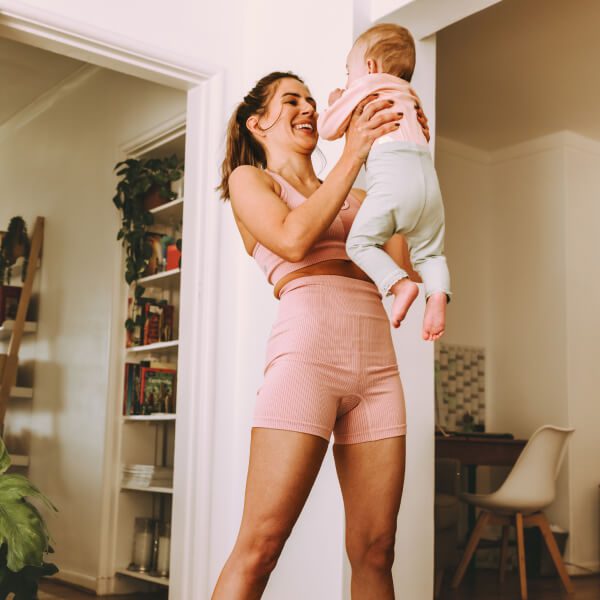 Woman smiling while holding baby