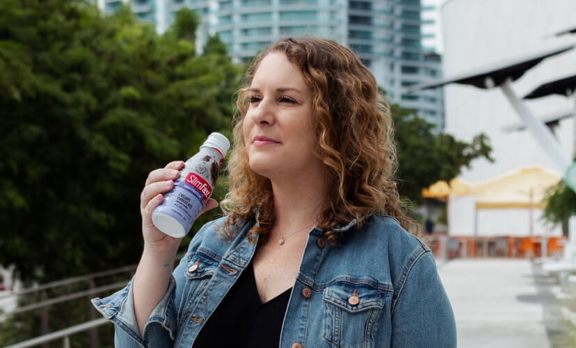 Woman holding SlimFast High Protein Drink