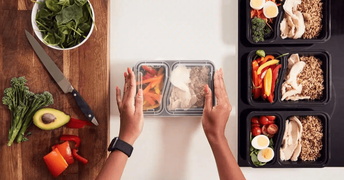 overhead shot of someone meal prepping food in a container