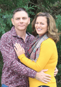 Amanda H. in a yellow sweater and her fiance Sam in a patterned shirt.