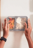 overhead shot of someone meal prepping food in a container